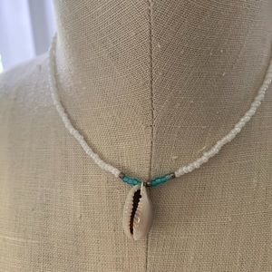 White and blue beaded necklace with shell